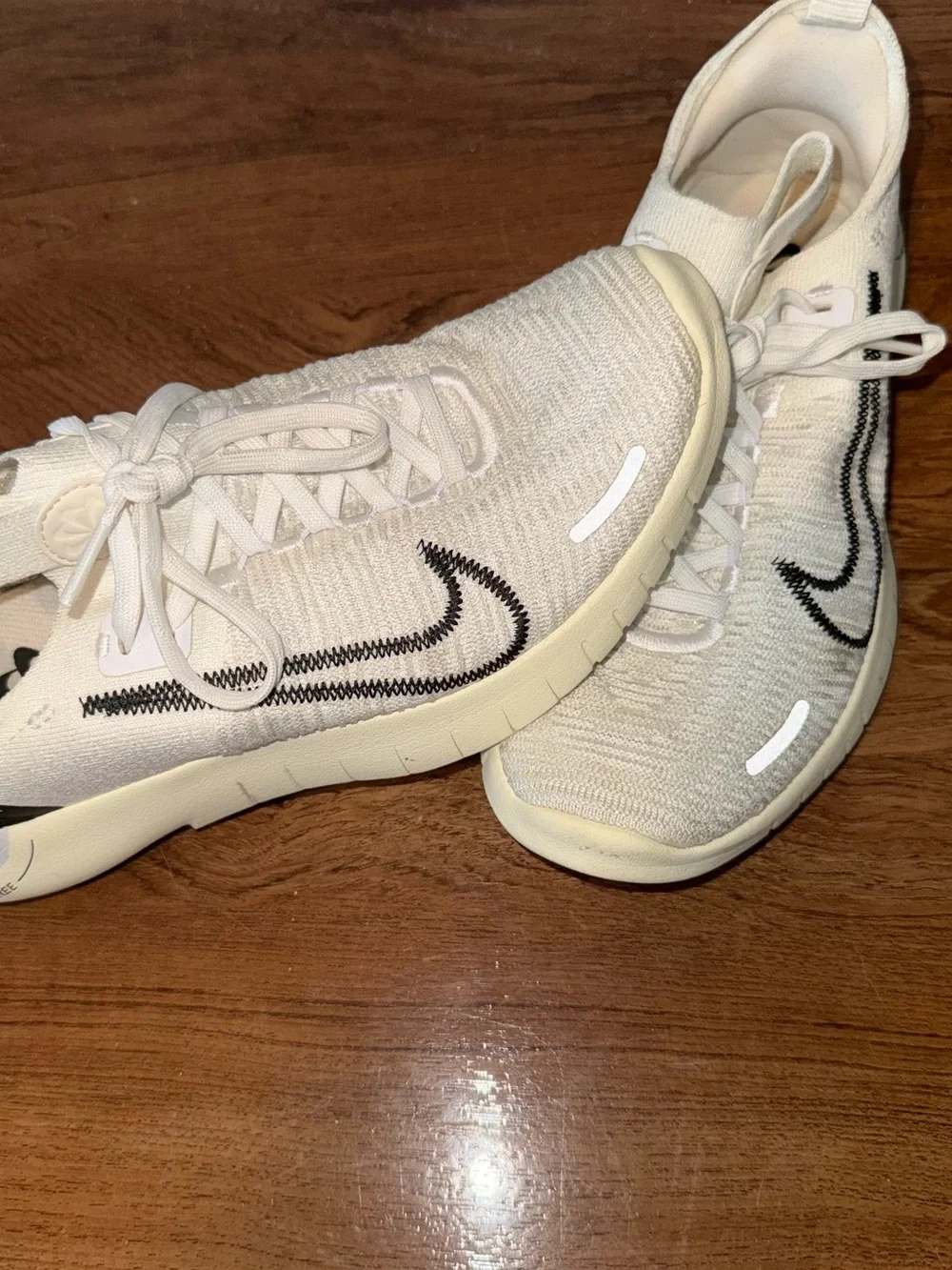Nike Cream Flyknit Sneakers with Black Swoosh